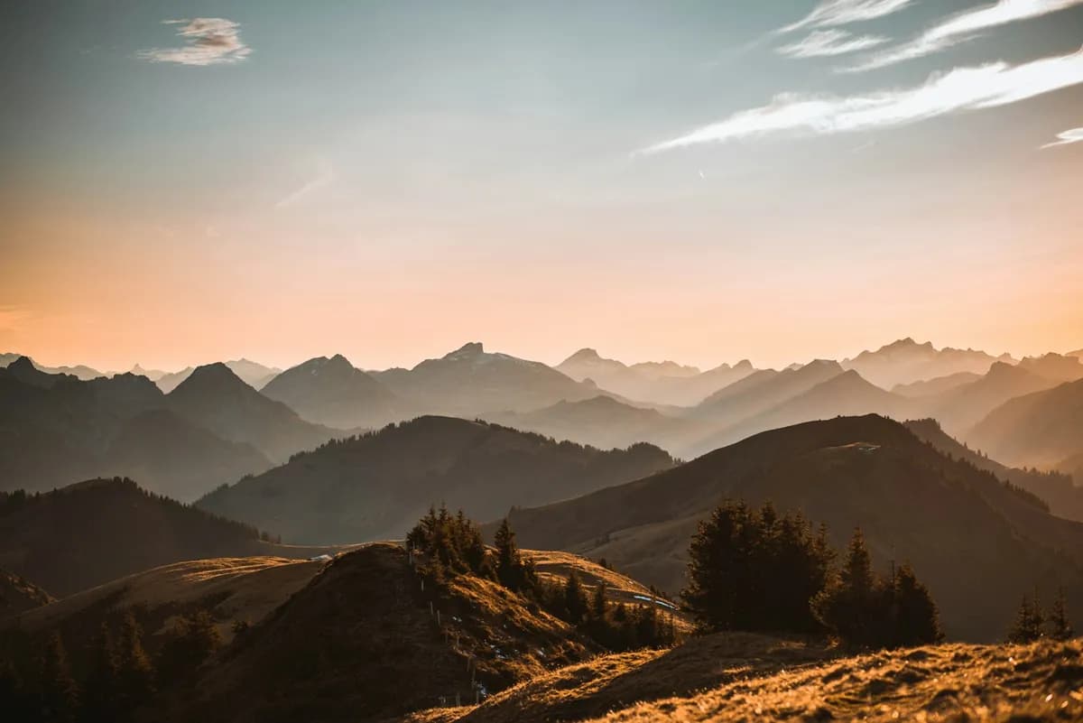 Featured landscape of layered mountain ridges at golden hour