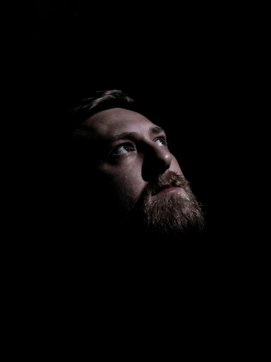 Low-light portrait of a bearded man