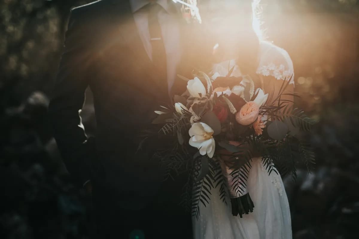 Bouquet held against a backlit veil